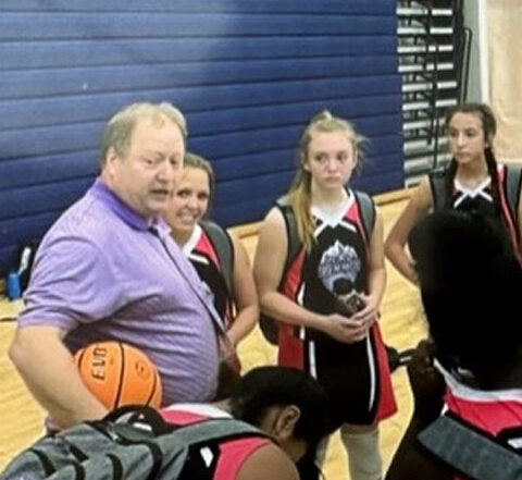 Photo of Kyle Ray in the Gilmer County High School gym coaching the Girls Basketball Team