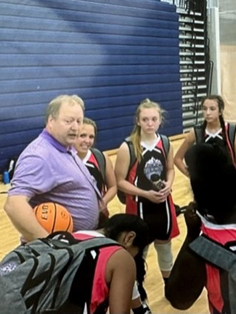 Photo of Kyle Ray in the Gilmer County High School gym coaching the Girls Basketball Team